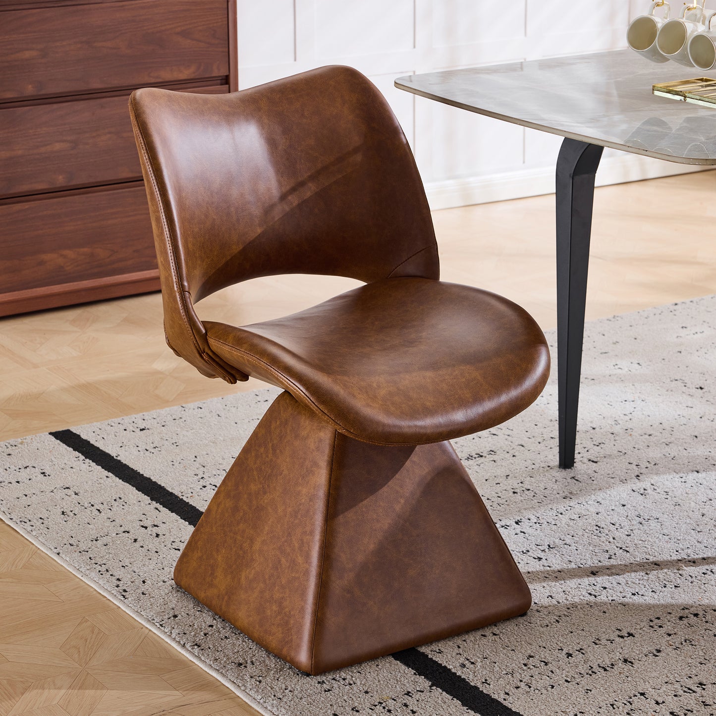 The swivel dining chair combines modern craftsmanship and can be combined in multiple sets. It is comfortable, artificial leather brown, and upholstered with modern high-back tables and chairs