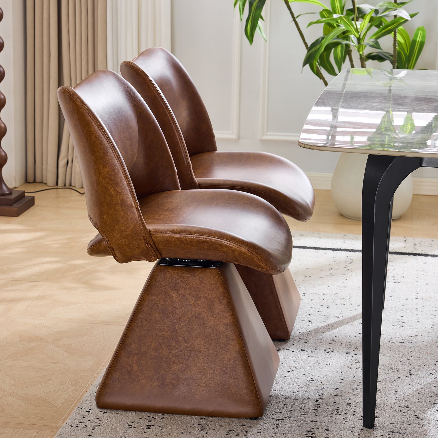 The swivel dining chair combines modern craftsmanship and can be combined in multiple sets. It is comfortable, artificial leather brown, and upholstered with modern high-back tables and chairs
