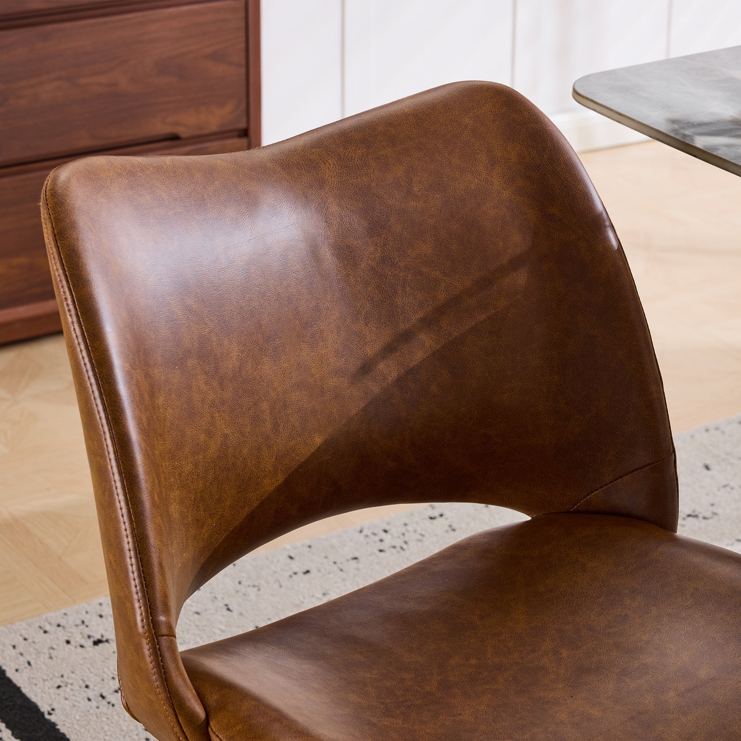 The swivel dining chair combines modern craftsmanship and can be combined in multiple sets. It is comfortable, artificial leather brown, and upholstered with modern high-back tables and chairs