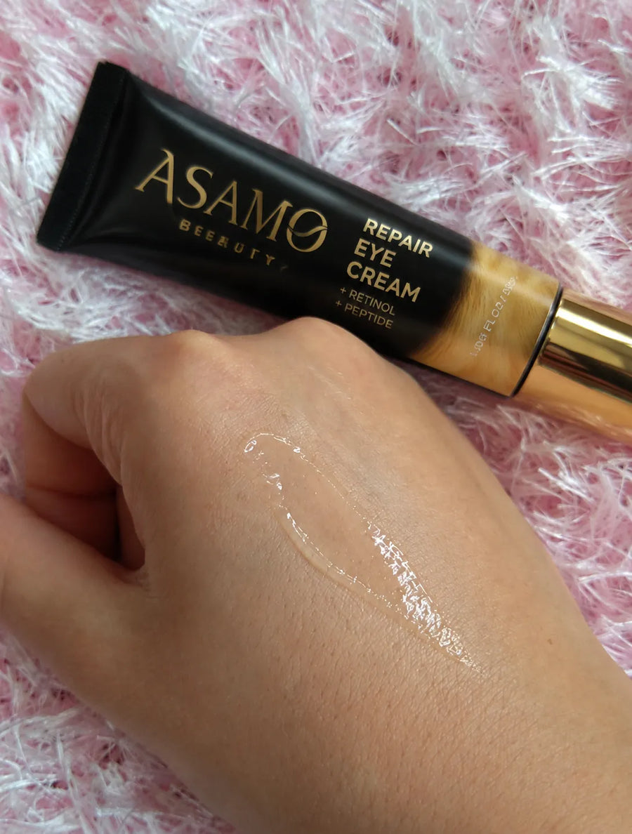 ASAMO Retinol + Peptide Eye Cream with a texture swatch on a hand