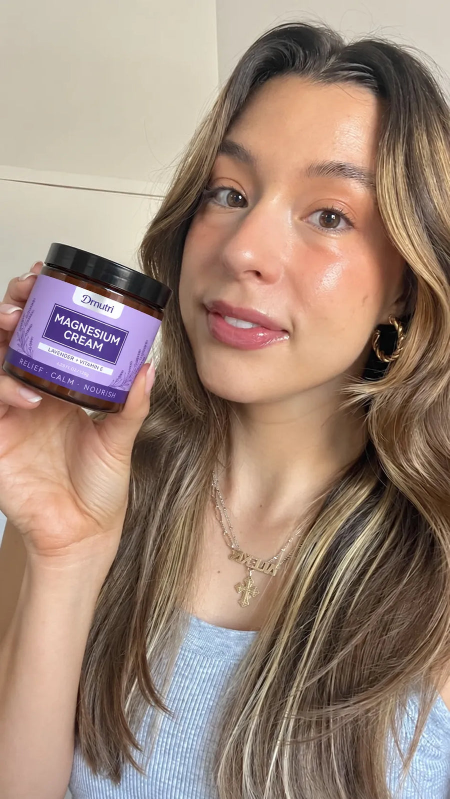 Drnutri Magnesium Cream held beside a face