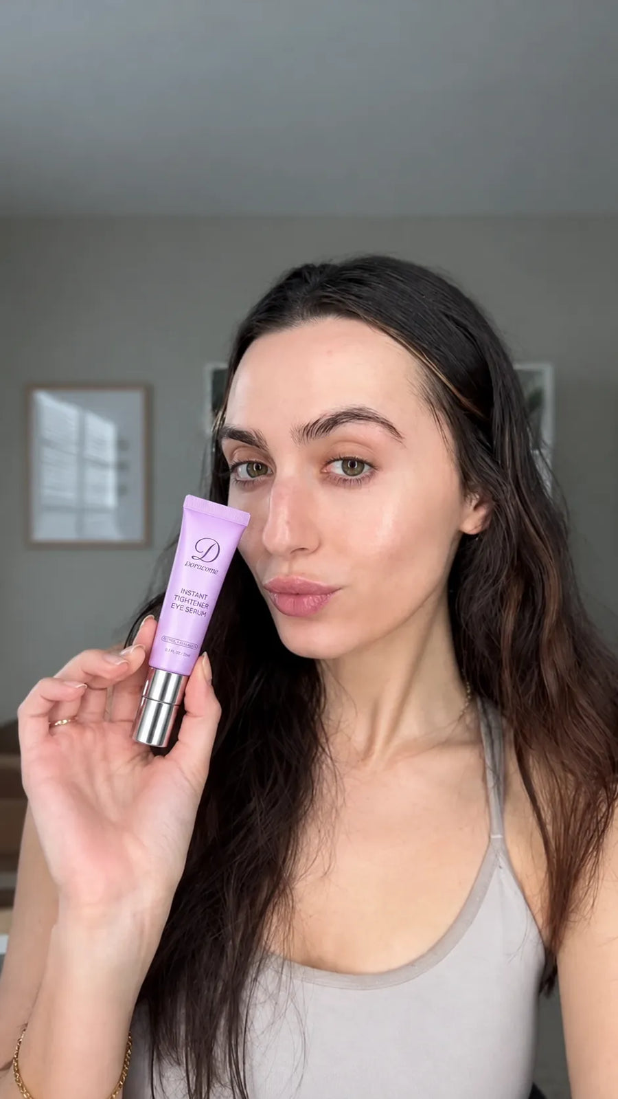 Doracome eye serum held beside a face