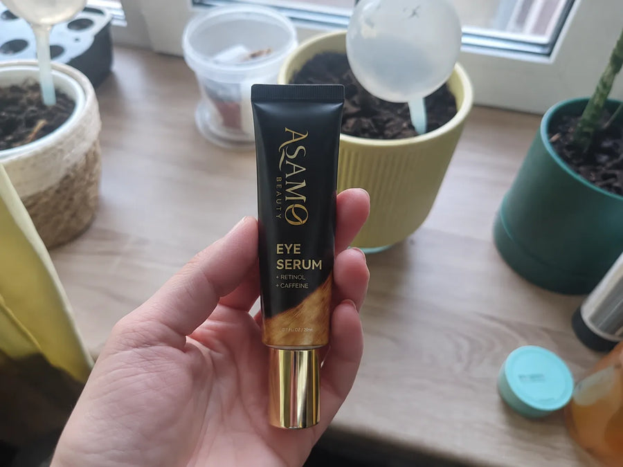 ASAMO Retinol + Caffeine Eye Serum held in a hand